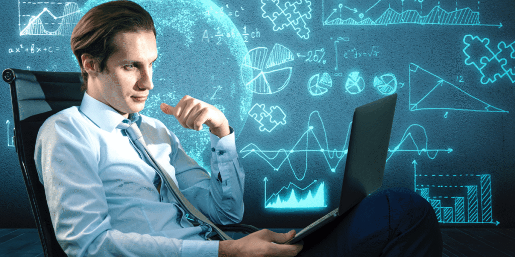 A thoughtful man in a shirt and tie sits with a laptop, surrounded by glowing blue graphs and equations on a dark wall, conveying focus and analysis.